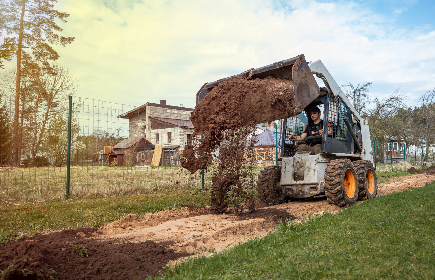 AA Tree Service skid-steer clearing and grading a residential lot in Massachusetts